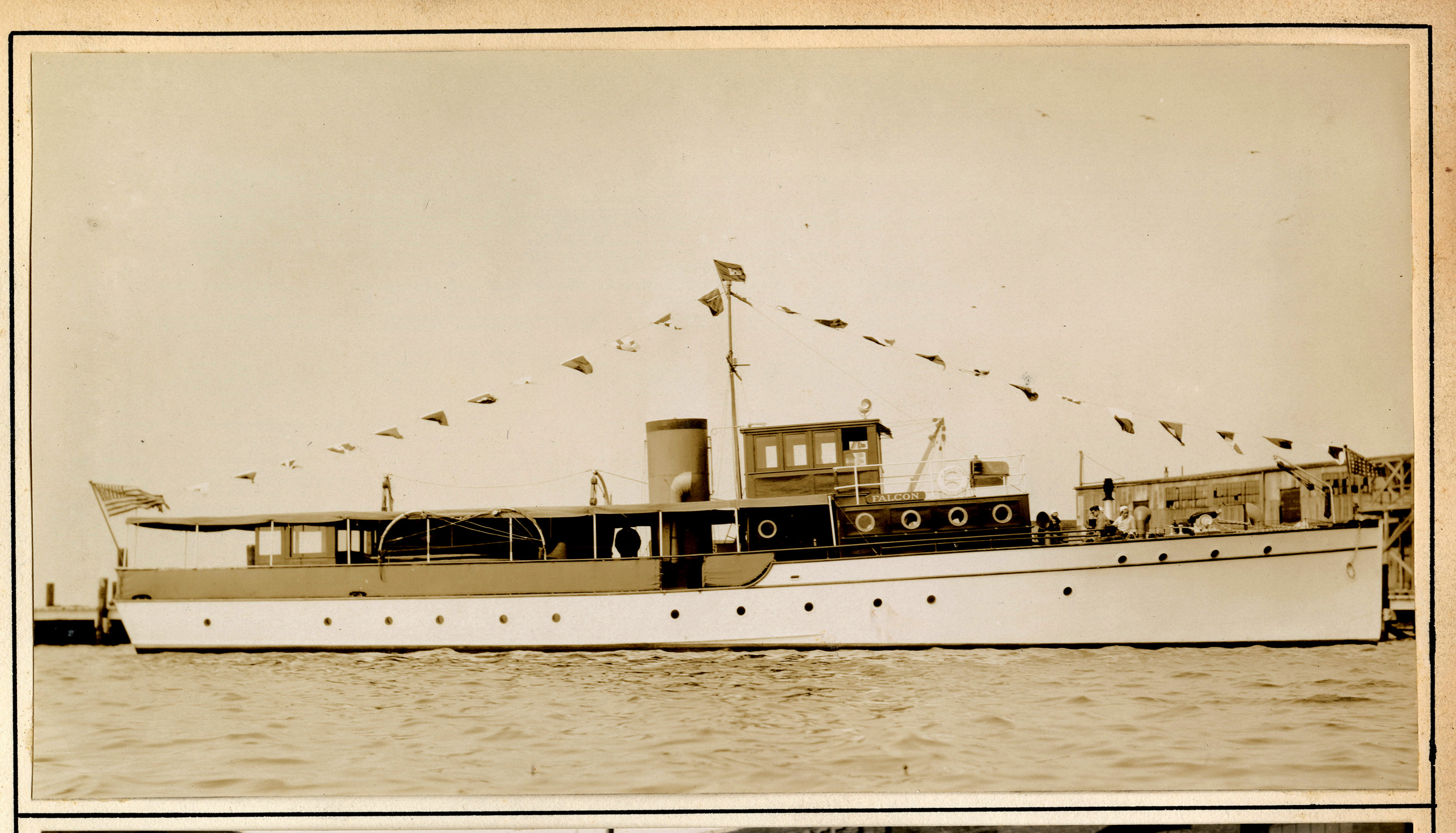 Shallow and slender boat with flags on a line